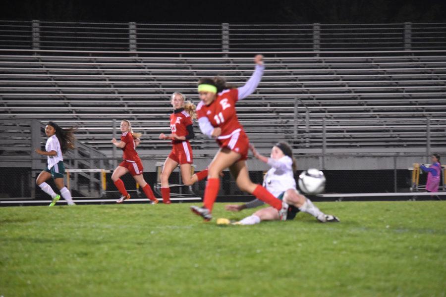 Girls varsity soccer player Wendy Murillo jumps over rival opponent as the soccer players are fighting to get control of the ball. “Girls are as competitive as boys,” soccer parent Kristina Garcia said.