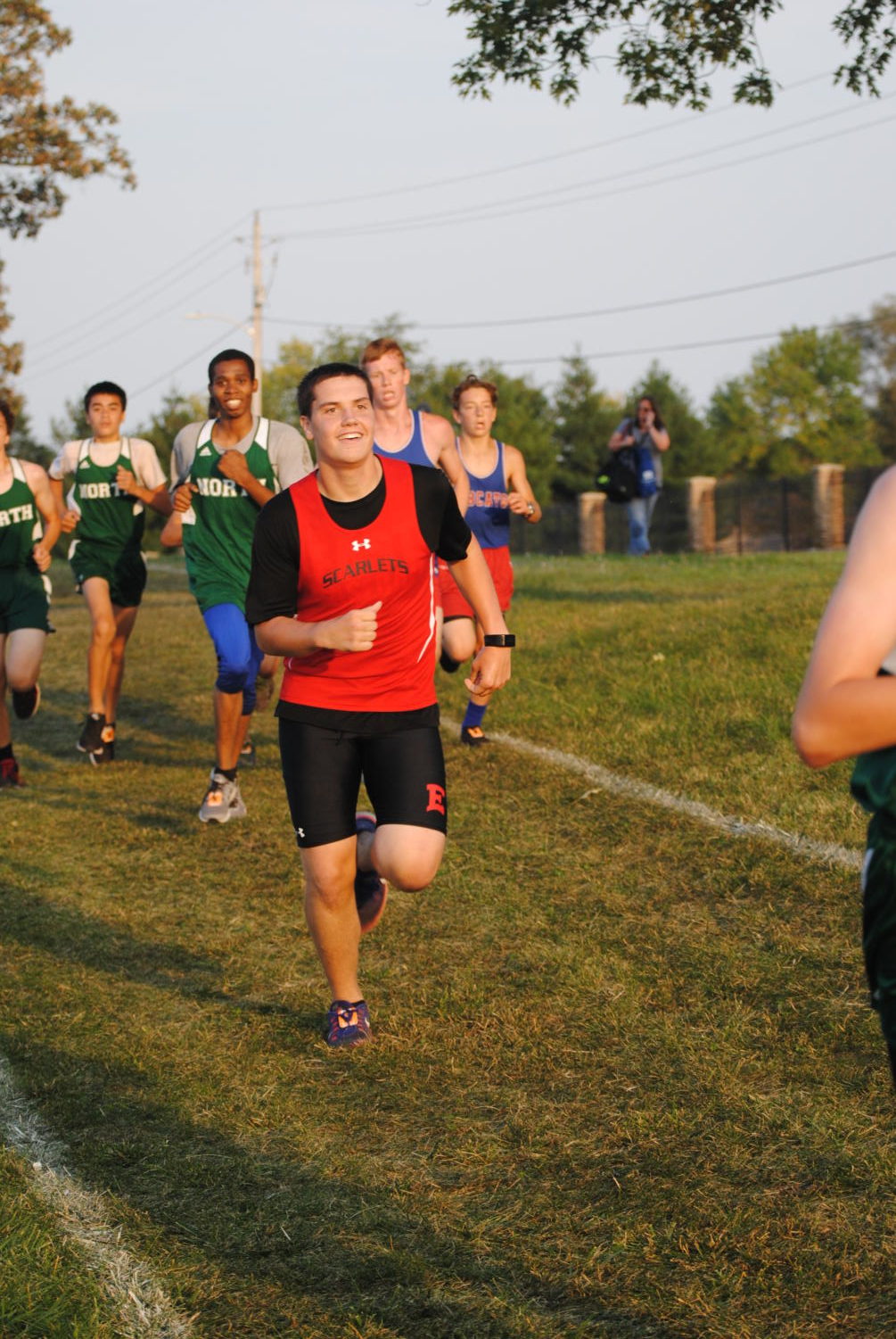 running to the finish line in order to help his team win. Kade Dolphin races with the East High School cross country team.